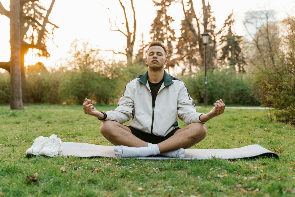 person meditating outdoors away from phone