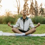 person meditating outdoors away from phone