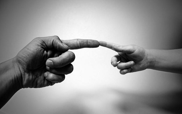 Hand reaching for a clean, folded tea towel