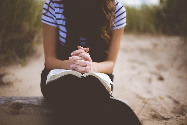 Person meditating outdoors, symbolizing inner peace and personal development.