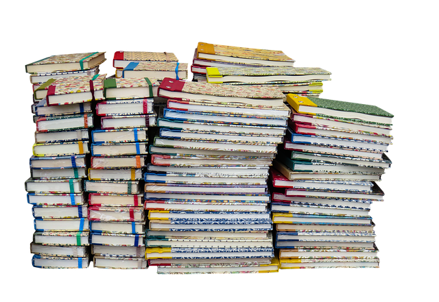 Stack of books and a journal, symbolizing learning and reflection for personal development.